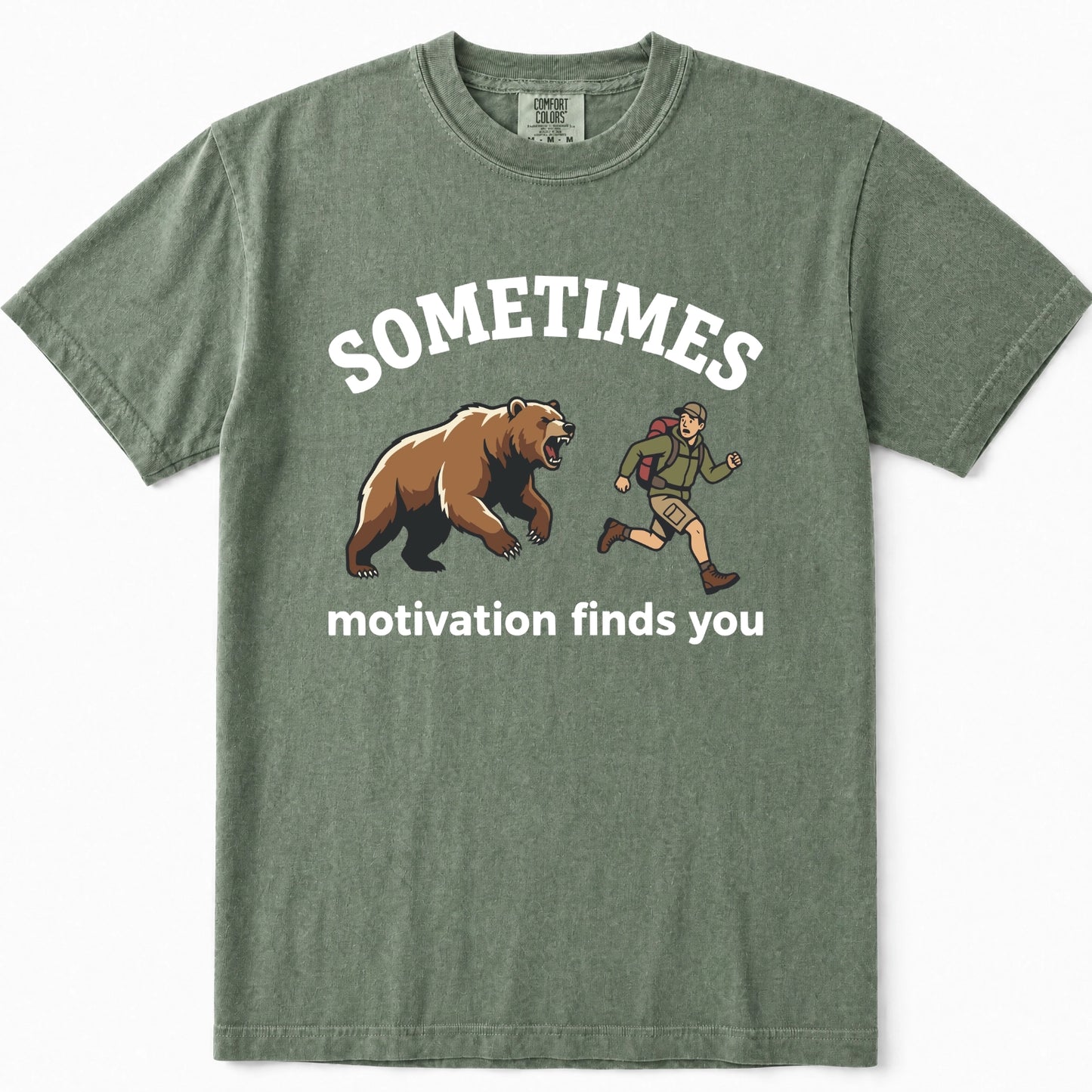 Moss green t-shirt featuring a graphic print of a brown bear and a hiking trail runner with the text 'SOMETIMES motivation finds you' in white.