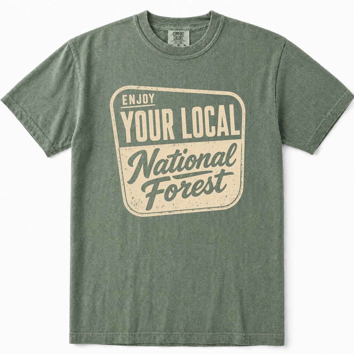 Moss green crewneck t-shirt featuring a distressed cream-colored graphic on the front that reads 'ENJOY YOUR LOCAL National Forest'.