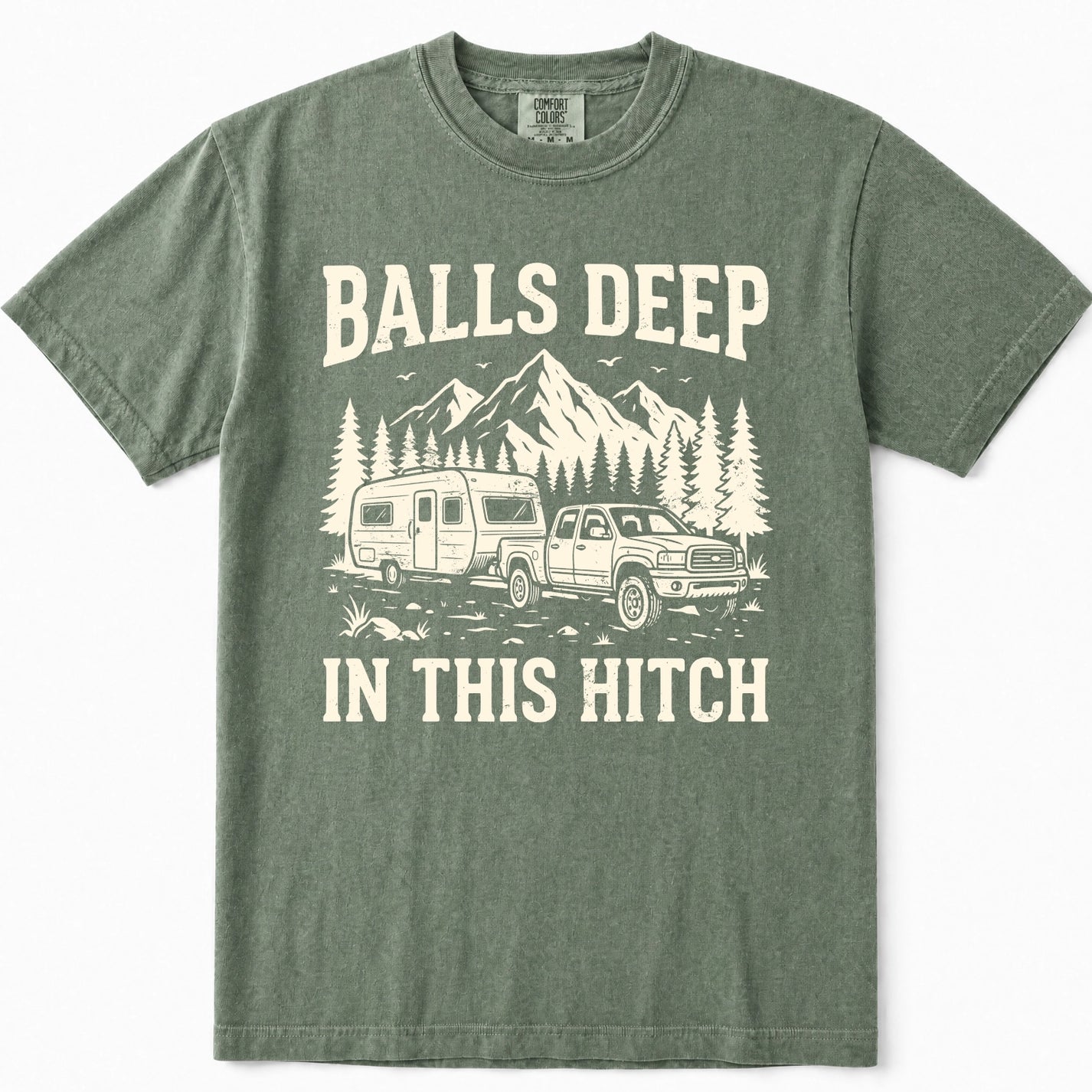 Moss green crewneck t-shirt featuring a vintage-style cream graphic of a pickup truck towing an RV with mountains and pine trees in the background, and the text 'BALLS DEEP IN THIS HITCH'.