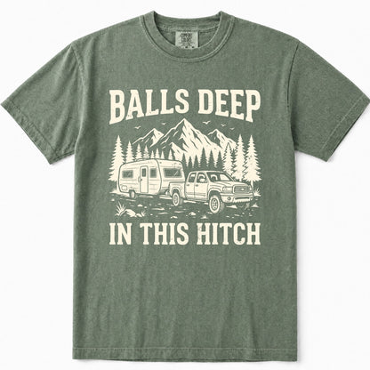 Moss green crewneck t-shirt featuring a vintage-style cream graphic of a pickup truck towing an RV with mountains and pine trees in the background, and the text 'BALLS DEEP IN THIS HITCH'.