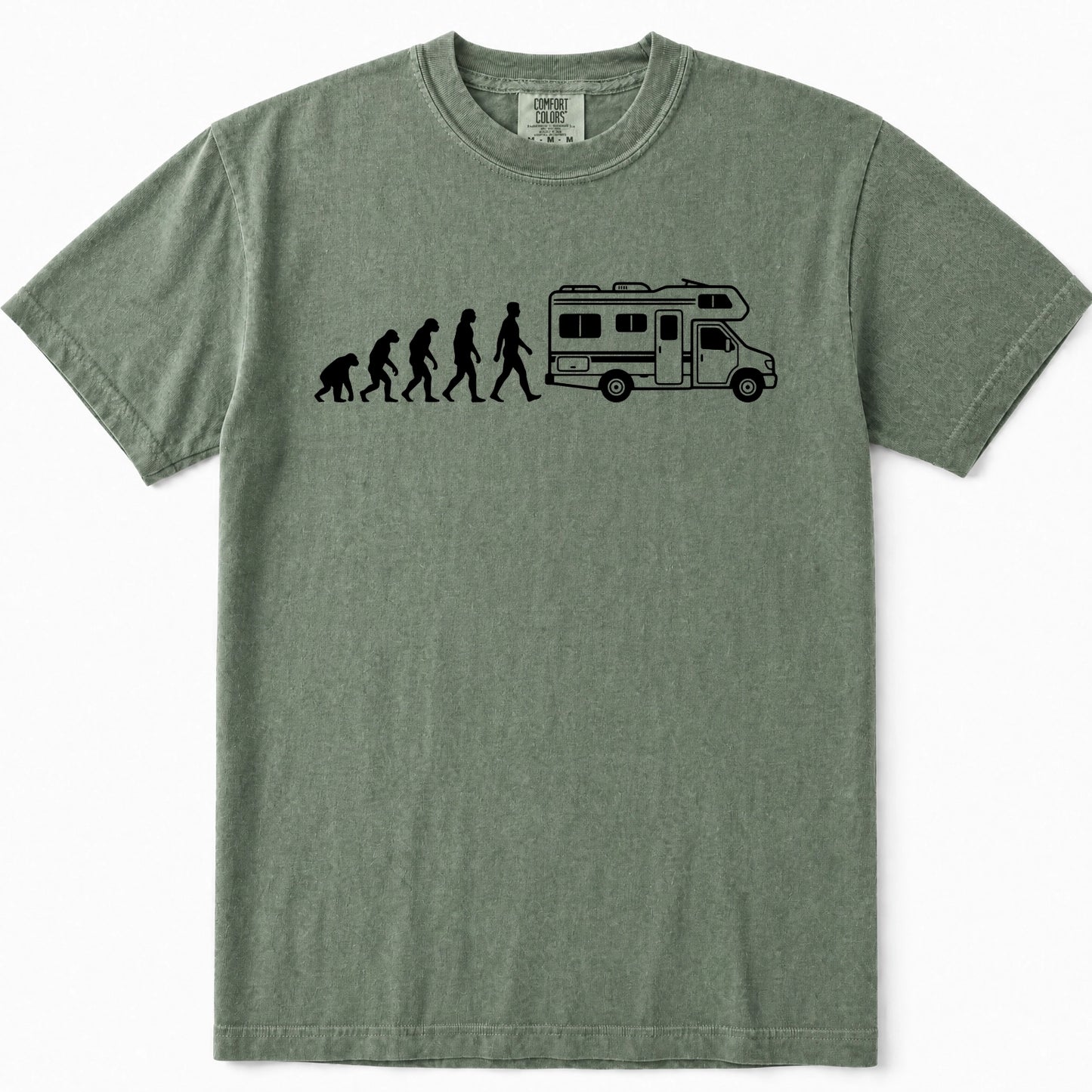 Moss green crewneck t-shirt featuring a black graphic print of the evolution of man leading up to a walking person next to a camper RV, displayed on a clean white background.