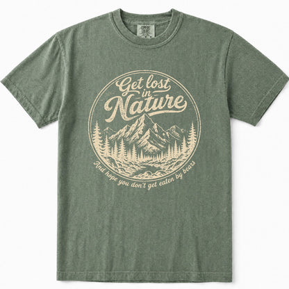 Moss green short-sleeve t-shirt with a vintage-style beige graphic on the chest. The graphic features a circular mountain and pine tree illustration with the text 'Get lost in Nature' and 'And hope you don't get eaten by bears'.