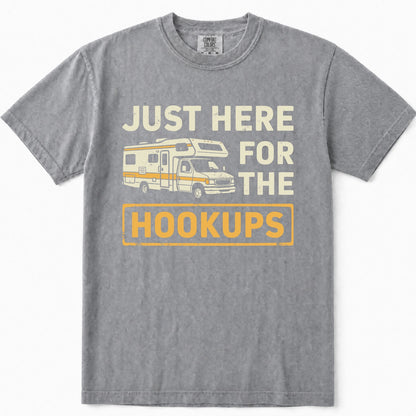 Grey short-sleeve t-shirt with a vintage-style graphic print that reads 'JUST HERE FOR THE HOOKUPS' in cream and yellow text, featuring an illustration of a camper van in the center.