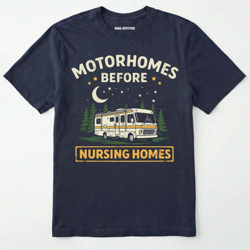 Navy blue t-shirt with a graphic of a retro class a motorhome and text 'Motorhomes Before Nursing Homes' on a white background.
