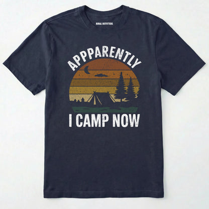 Navy t-shirt with ⊜apparently i camp now⊝ in white text and a vintage sunset camping scene on a white background.