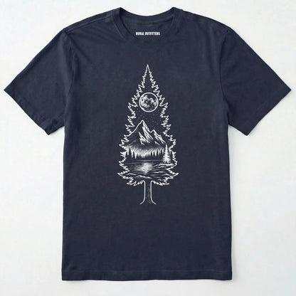 Navy tree t-shirt featuring a detailed white graphic of a pine tree silhouette. the tree outline contains a landscape scene: a mountain peak rising over a forested shoreline, with its reflection visible in a lake below. above the mountain is a starry night sky and a full or partial circle representing the moon or sun.
