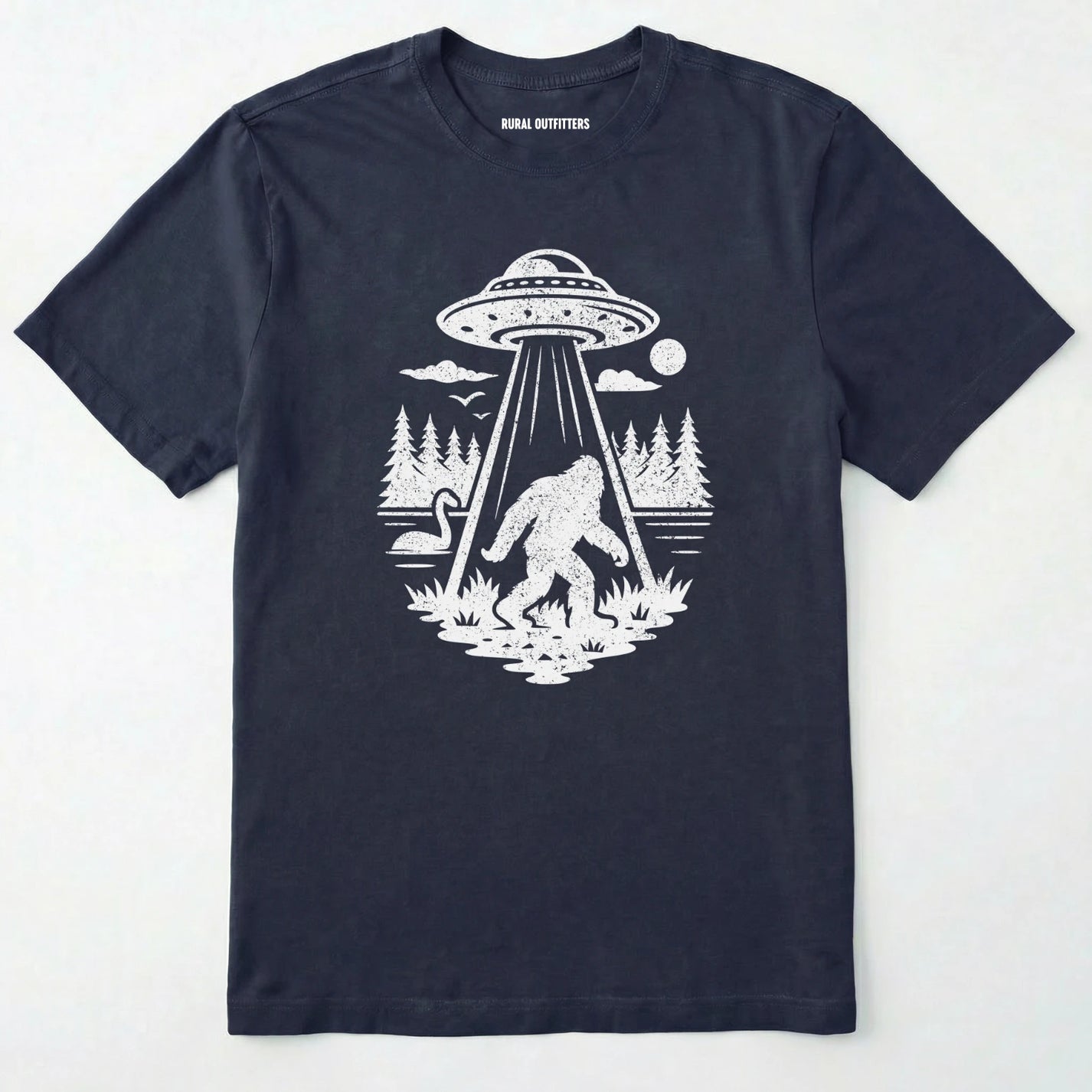 Navy monster shirt with Bigfoot, a forest scene, and a UFO beam graphic on a white background.