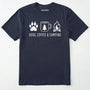 Navy camping dog shirt with paw print, coffee mug and campfire design on a white background.