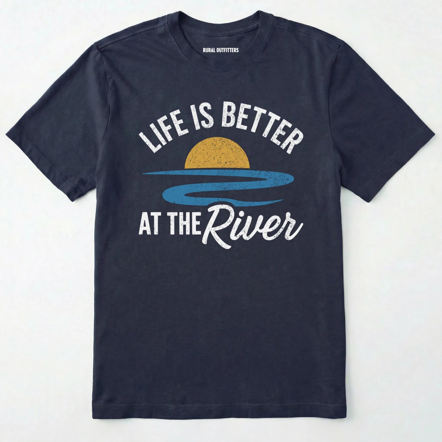 Navy river shirt with 'life is better at the river' design, paired with brown boots and a green backpack on a light grey background.
