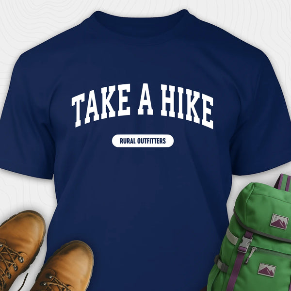 Navy blue t-shirt with 'Take a Hike' text, brown boots, and green backpack on a white background