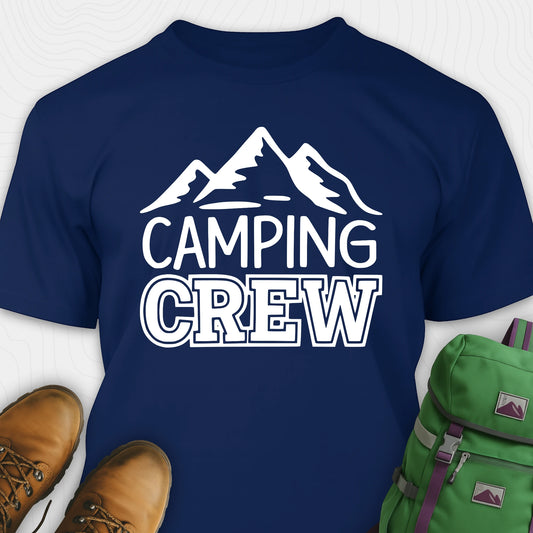 Navy blue camping crew t-shirt with 'Camping Crew' text and mountain graphic, paired with hiking boots and a green backpack.