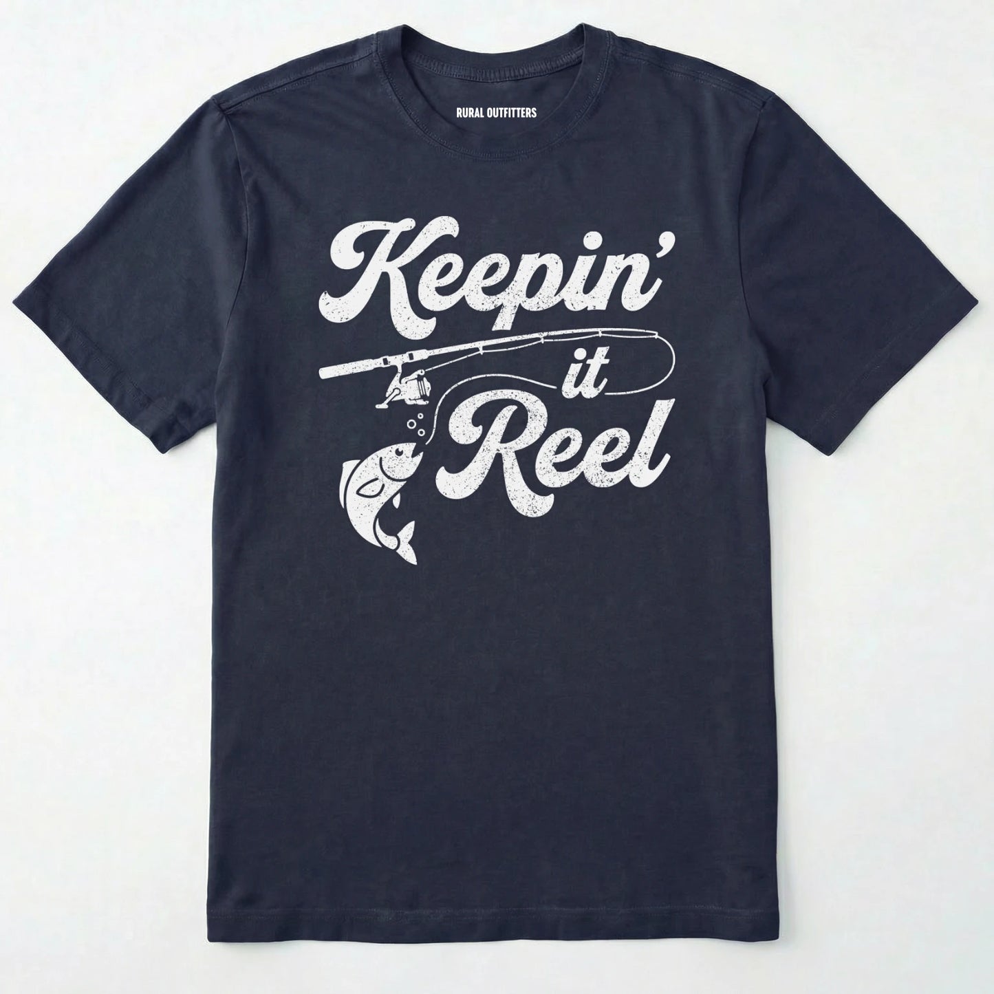 Navy t-shirt with 'keepin' it reel' text and fishing graphic on a white background
