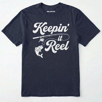 Navy t-shirt with 'keepin' it reel' text and fishing graphic on a white background