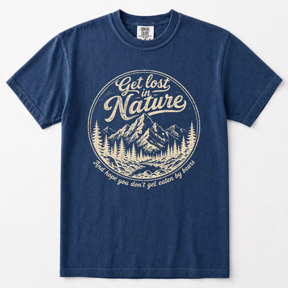 Navy blue short-sleeve t-shirt with a vintage-style circular graphic on the chest. The graphic features a cream-colored mountain and pine tree illustration with the text 'Get lost in Nature' and 'You hope you don't get eaten by bears'.