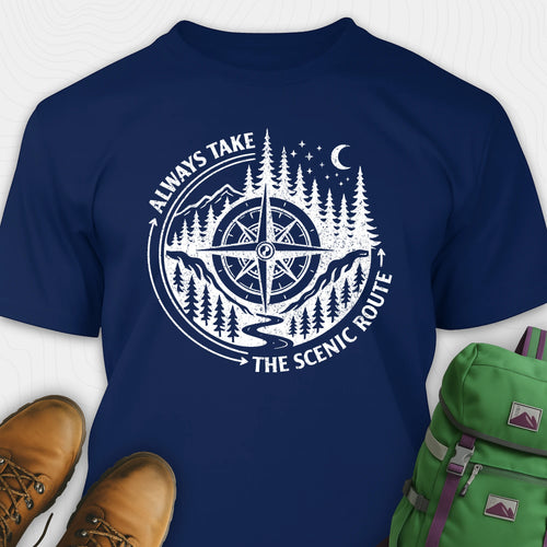 Navy blue always take the scenic route t-shirt with compass graphic and text, paired with hiking boots and a green backpack.