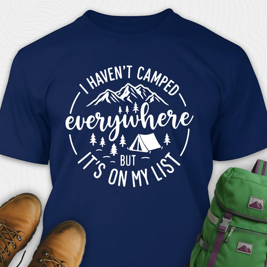 Navy funny camping shirt saying with mountains, trees, tent graphic and "I Haven't Camped Everywhere But It's On My List" text