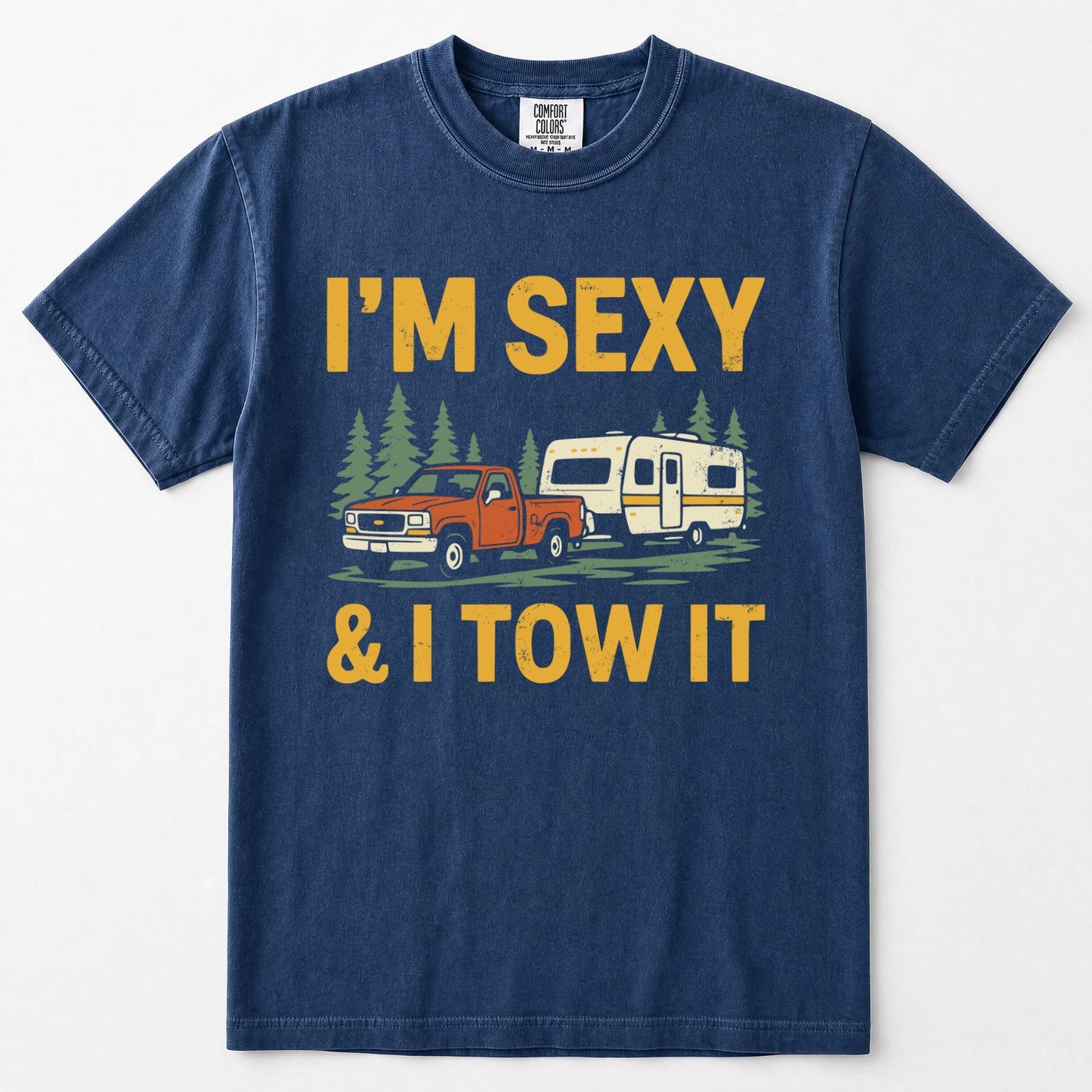 Navy blue crewneck t-shirt featuring a graphic print of an orange pickup truck towing a cream camper trailer, with the text 'I'M SEXY & I TOW IT' in yellow above and below the illustration.