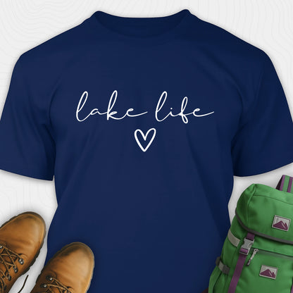 Navy blue lake life shirt with 'lake life' text and heart symbol, paired with brown boots and a green backpack.