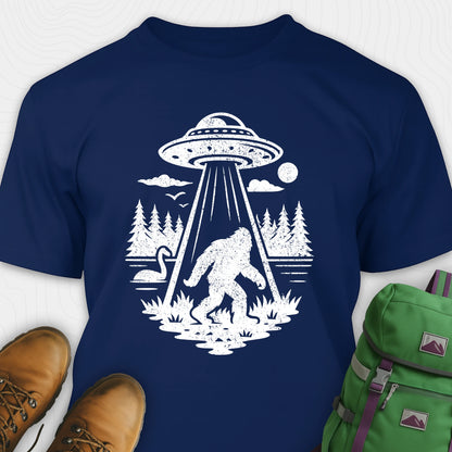 Navy monster shirt with bigfoot, forest scene, and ufo beam graphic