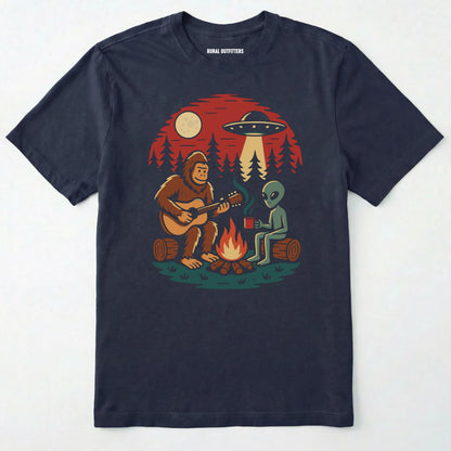 Navy alien shirt with ufo, bigfoot camping by the fire design on a white background.