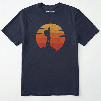 Navy retro sunset t-shirt with hiker silhouette on a white background.