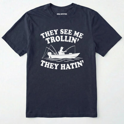 Navy t-shirt with white graphic and text on a light grey background