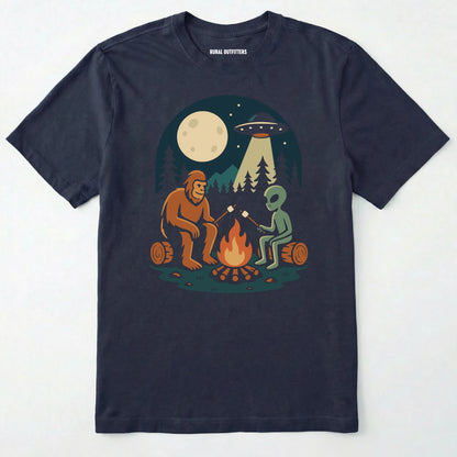 Navy bigfoot and alien shirt, featuring a sasquatch and an alien roasting marshmallows around a campfire with moon and ufo graphic on a white background.
