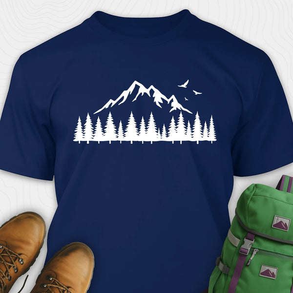 Navy wild t-shirt with a minimalist mountain and pine tree graphic, shown flat with boots and a backpack