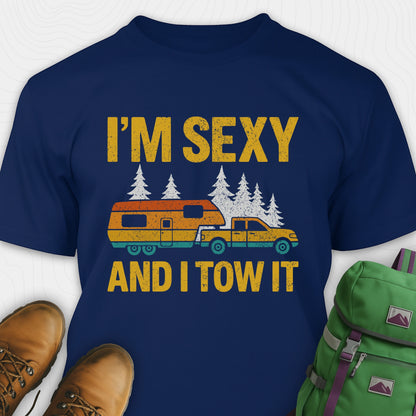 Navy blue fifth wheel t-shirt with “I’m Sexy and I Tow It” in distressed yellow text and a retro truck towing a camper graphic.