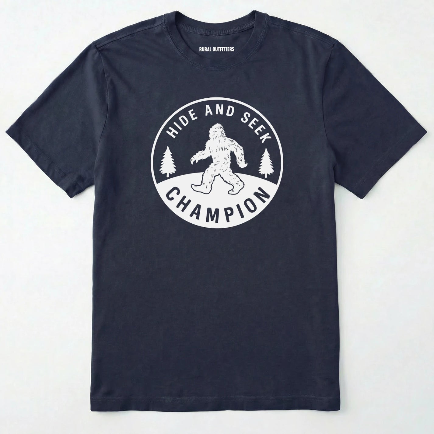 Navy bigfoot hide and seek champion shirt with forest emblem on a white background.