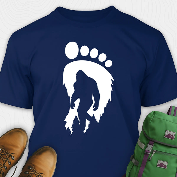 Navy bigfoot t-shirt with cryptid themed footprint graphic and sasquatch silhouette