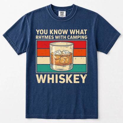 Navy blue short-sleeve t-shirt with a vintage-style graphic on the front. The graphic features the text 'YOU KNOW WHAT RHYMES WITH CAMPING' above a retro striped background and an illustration of a whiskey glass, followed by the word 'WHISKEY' below.