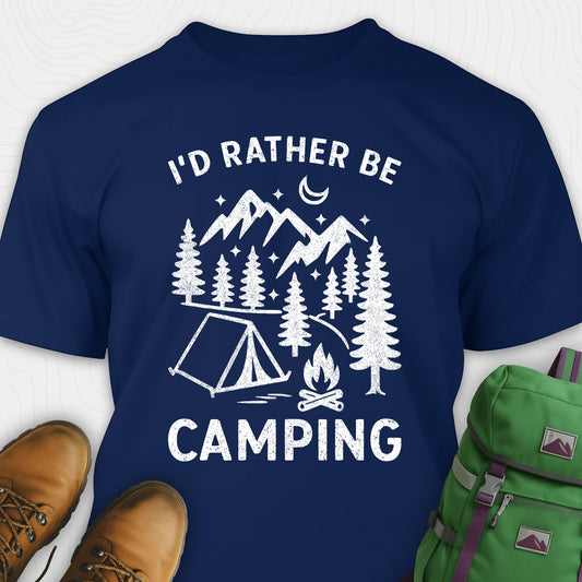 Navy blue t-shirt with 'I'd Rather Be Camping' graphic design, brown boots, and green backpack on a white background