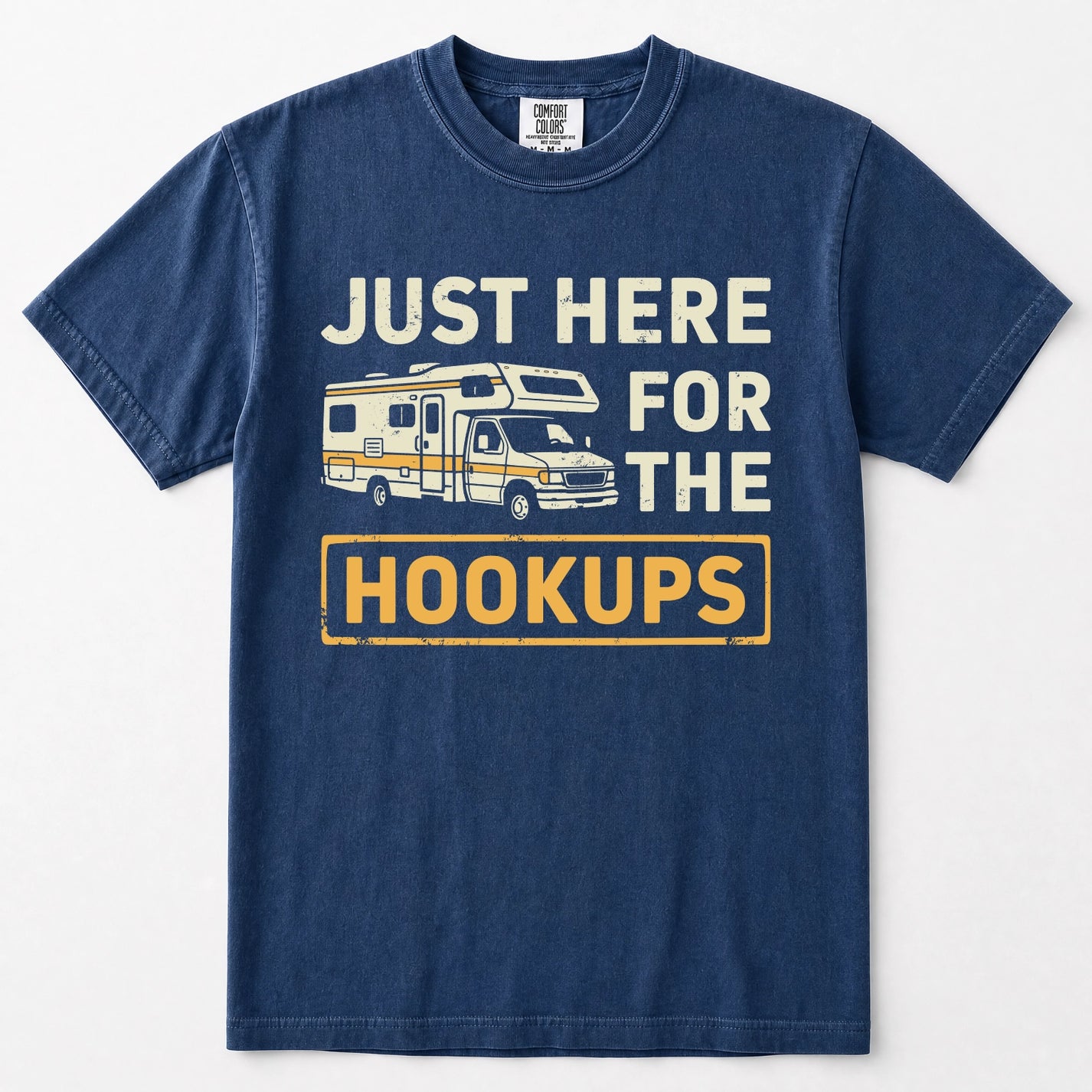 Navy blue short-sleeve t-shirt with a vintage-style graphic print featuring a camper van and the text 'JUST HERE FOR THE HOOKUPS' in distressed cream and yellow lettering, displayed on a clean white background.