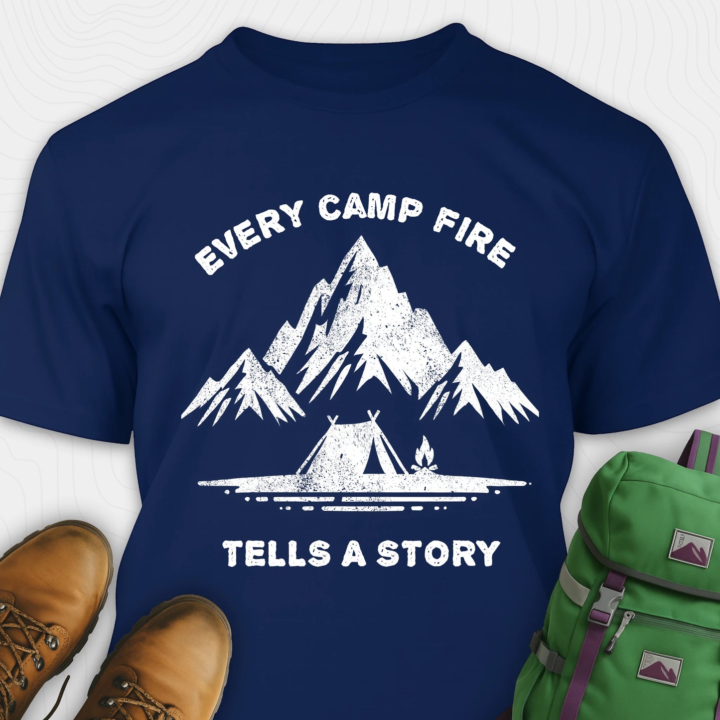 Navy campfire story shirt with mountains and tent graphic and "every camp fire tells a story" text