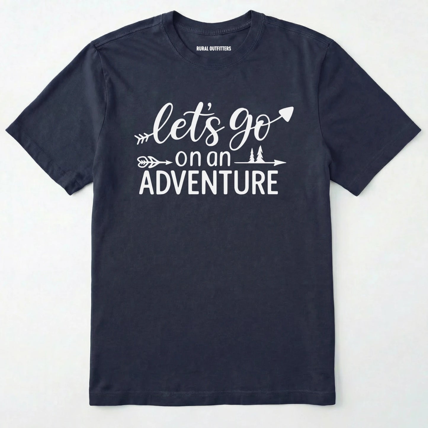 Navy lets go on an adventure shirt with an arrow and trees graphic on a light grey background.