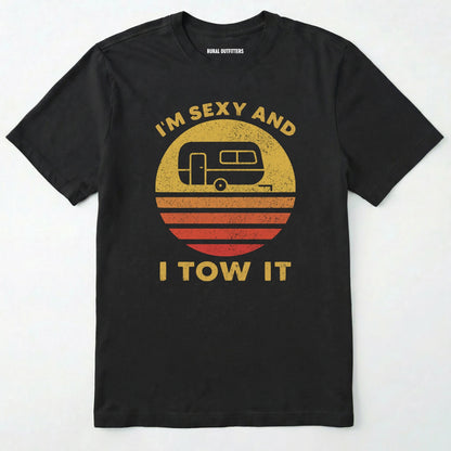 Black trailer shirt with retro camper and sunset graphic, and "i'm sexy and i tow it" text on a white background.