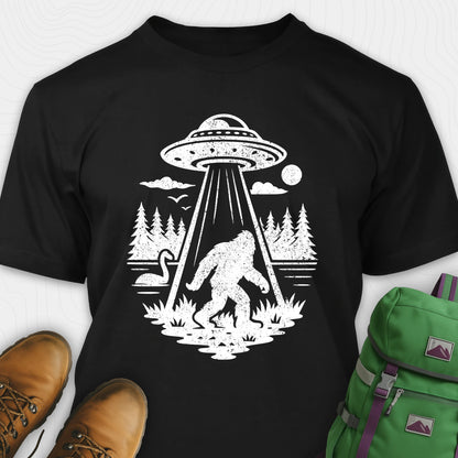 Black monster shirt with bigfoot, forest scene, and ufo beam graphic