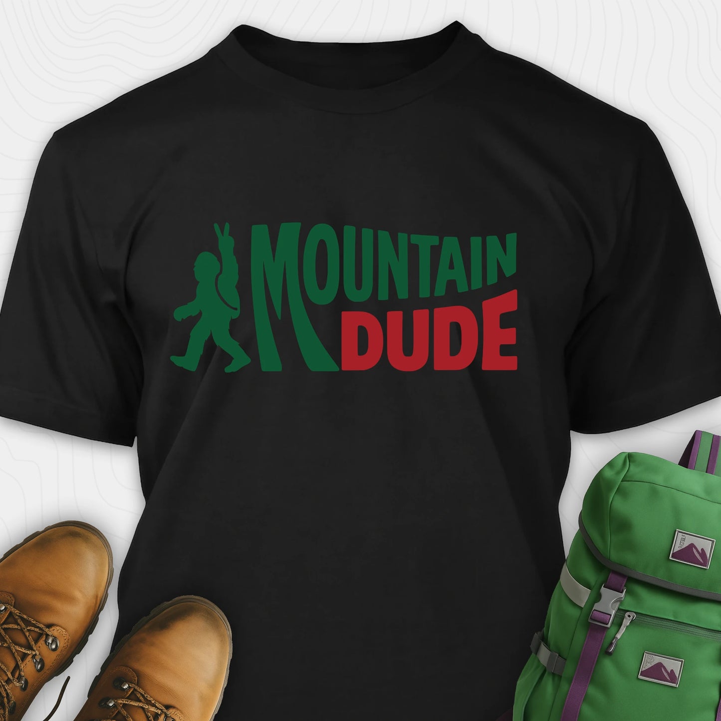 Black Mountain Dude shirt with green and red text and Bigfoot graphic.