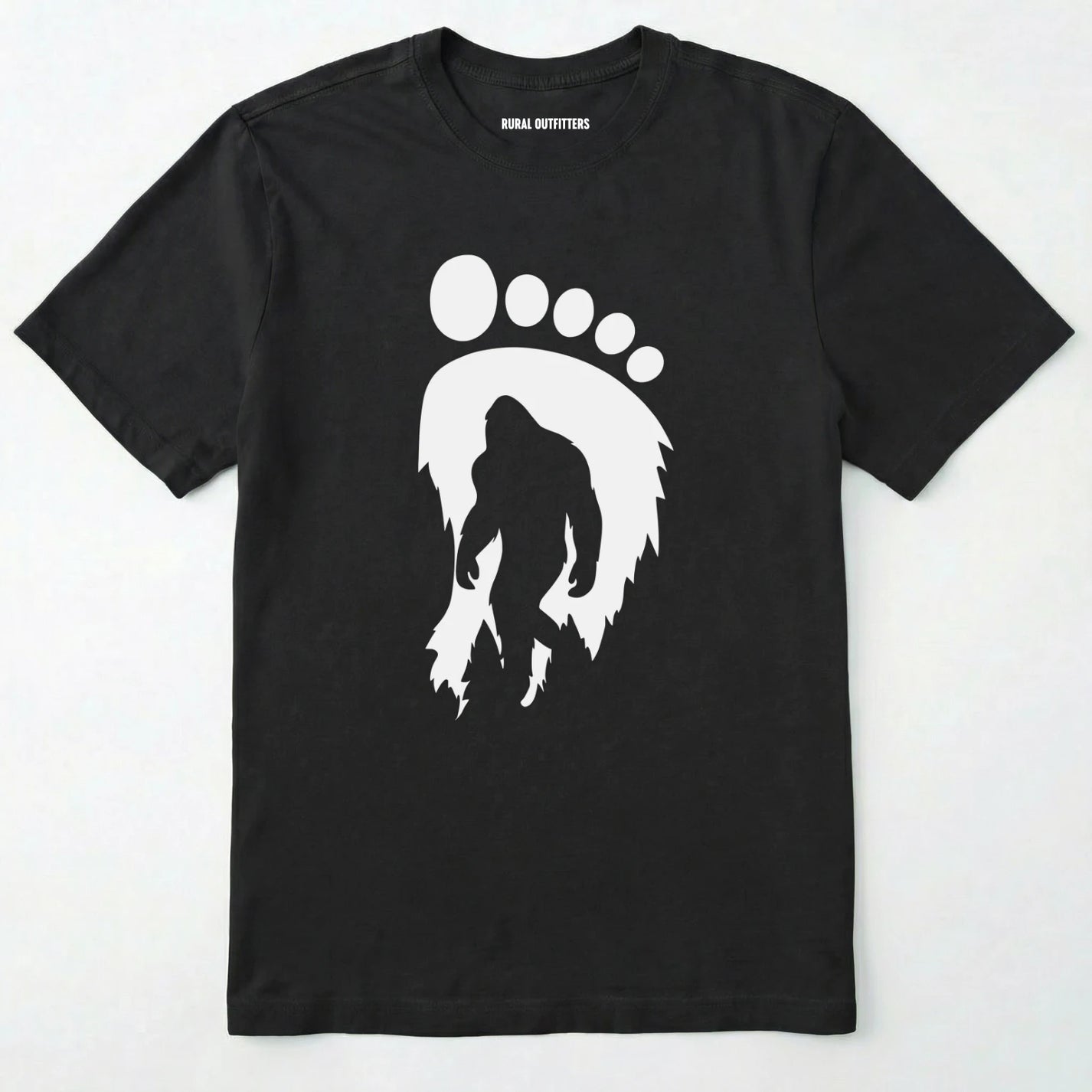 Black bigfoot t-shirt with cryptid-themed footprint graphic and sasquatch silhouette on a white background.