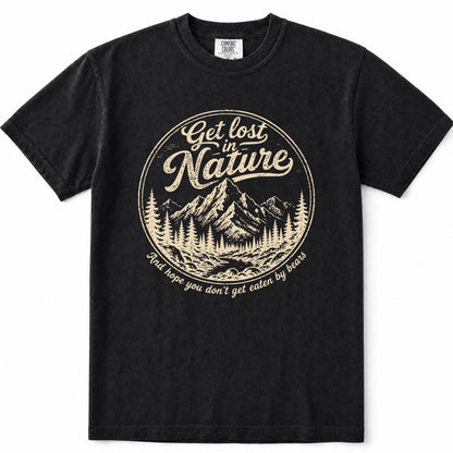 Black short-sleeve crewneck t-shirt with a vintage-style beige graphic on the chest. The graphic features a circular mountain and pine tree illustration with the text 'Get lost in Nature' and 'You hope you don't get eaten by bears'.