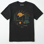 Black wilderness explorer shirt with sunset campfire scene with tent, trees, and mountains design on a white background.