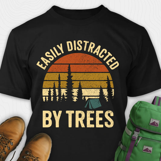 Black funny tree shirt with "easily distracted by trees" text and retro sunset design