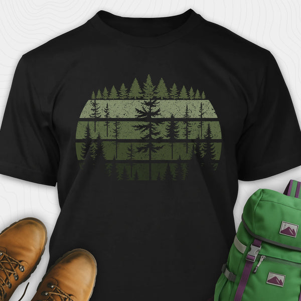 Black forest shirt with distressed pine tree design, and green backpack on a white background