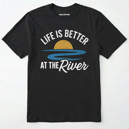 Black river shirt with 'life is better at the river' design, paired with brown boots and a green backpack on a light grey background.