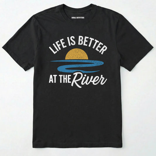 Black river shirt with 'life is better at the river' design, paired with brown boots and a green backpack on a light grey background.