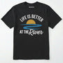 Black river shirt with 'life is better at the river' design, paired with brown boots and a green backpack on a light grey background.