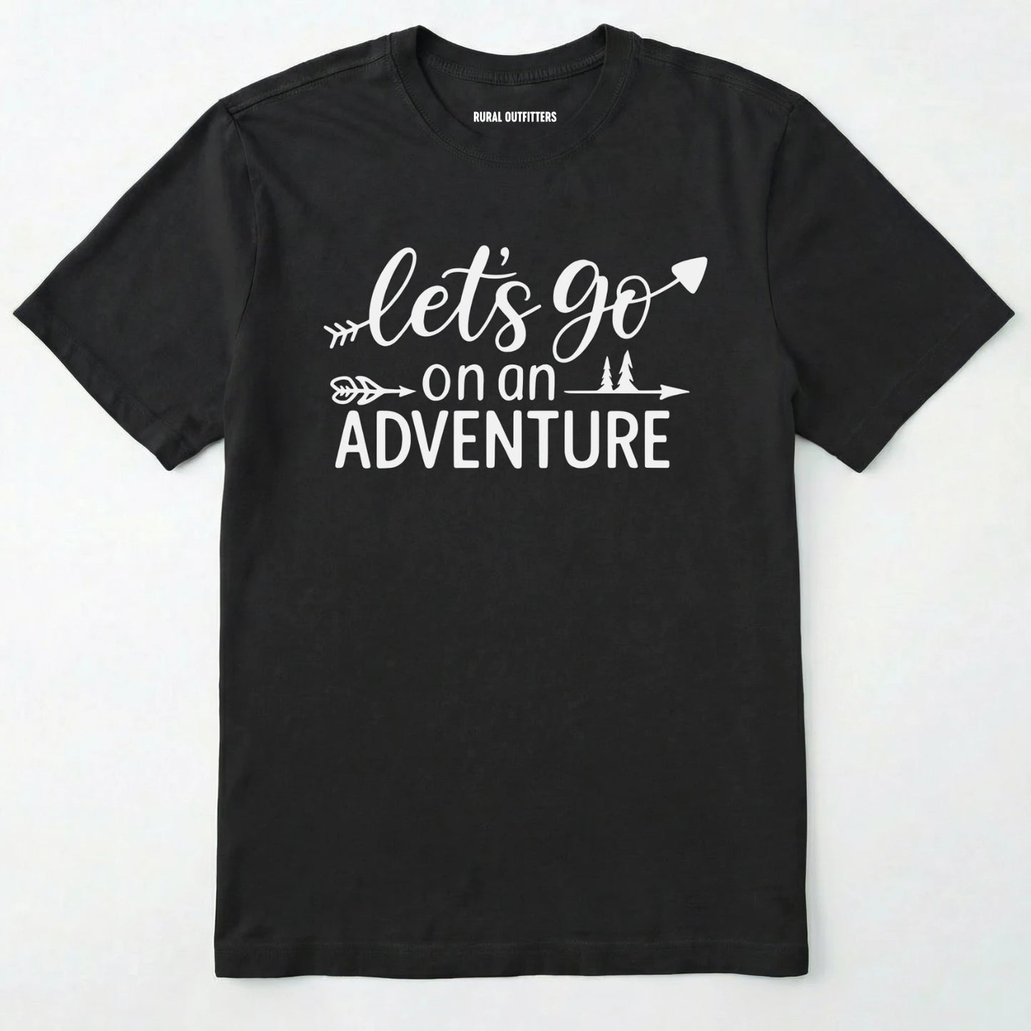 Black lets go on an adventure shirt with an arrow and trees graphic on a light grey background.
