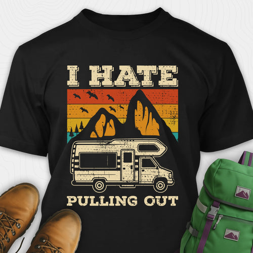 Black I hate pulling out shirt with a graphic design of an RV and mountains, displayed with brown boots and a green backpack.
