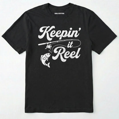 Black t-shirt with 'keepin' it reel' graphic and fishing rod design on a white background